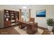 A home office featuring a wood desk, bookcase, hardwood floors, and natural light at 4329 Castleton Rd, Charlotte, NC 28211