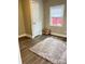 A tidy bedroom with hardwood floors, a cozy rug, window with blinds, and a closet at 507 E Maple Ave, Gastonia, NC 28054