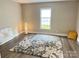 A well-lit bedroom boasting hardwood floors, a bright window, and minimalist decor at 507 E Maple Ave, Gastonia, NC 28054