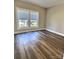 Bedroom with wood floors, neutral paint and two windows providing ample natural light at 507 E Maple Ave, Gastonia, NC 28054