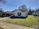 Charming home exterior with mature trees, manicured lawn and a paved driveway at 507 E Maple Ave, Gastonia, NC 28054