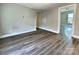 Spacious Living Room featuring wood floors and neutral paint, with doorways leading to other rooms at 507 E Maple Ave, Gastonia, NC 28054