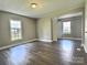 Bright living room featuring wood floors and neutral paint, with many windows throughout at 507 E Maple Ave, Gastonia, NC 28054