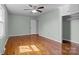 Large bedroom with hardwood floors, ceiling fan, closet, and natural light at 512 Washington St, Cramerton, NC 28032