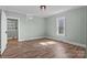 Light-filled bedroom with wood-look flooring, neutral walls, and classic ceiling fixture at 512 Washington St, Cramerton, NC 28032