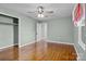 Spacious bedroom with hardwood flooring, ceiling fan, and a large closet at 512 Washington St, Cramerton, NC 28032