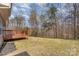 Spacious backyard featuring a wood deck and mature trees at 6087 Diamond Pl, Harrisburg, NC 28075