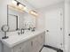 Bathroom featuring double sinks with a large mirror and modern fixtures at 6087 Diamond Pl, Harrisburg, NC 28075