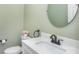 Elegant half bathroom features a stylish mirror and neutral color scheme at 6087 Diamond Pl, Harrisburg, NC 28075