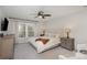 Bright bedroom featuring a comfortable bed with lamps and neutral decor at 6087 Diamond Pl, Harrisburg, NC 28075