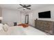 Cozy bedroom features a bed and an entertainment center with a TV at 6087 Diamond Pl, Harrisburg, NC 28075