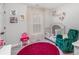 Cozy bedroom with plush green chair, pink rug, and charming decor at 6087 Diamond Pl, Harrisburg, NC 28075