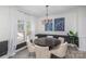 Elegant dining room with wainscotting, round table, and modern chandelier at 6087 Diamond Pl, Harrisburg, NC 28075