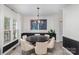 Elegant dining room with wainscotting, round table, and modern chandelier at 6087 Diamond Pl, Harrisburg, NC 28075