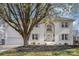 Charming two-story white brick home with lush landscaping and an inviting front entrance at 6087 Diamond Pl, Harrisburg, NC 28075