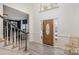 Inviting foyer with hardwood floors, staircase, and an elegant wood front door at 6087 Diamond Pl, Harrisburg, NC 28075