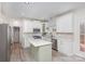 Bright kitchen with white cabinets, stainless steel appliances, and a light green kitchen island at 6087 Diamond Pl, Harrisburg, NC 28075