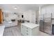 Open floor plan showcasing kitchen island with white countertops and stainless steel appliances at 6087 Diamond Pl, Harrisburg, NC 28075