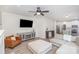 Bright living room with a gray media center, comfortable seating, and hardwood floors at 6087 Diamond Pl, Harrisburg, NC 28075