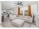 Open concept living room with a comfortable sectional sofa, hardwood floors, and natural light at 6087 Diamond Pl, Harrisburg, NC 28075