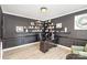 Stylish office with dark walls, built-in shelving, and modern desk at 6087 Diamond Pl, Harrisburg, NC 28075