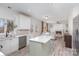 Bright open concept kitchen and living area features a kitchen island and fireplace at 6087 Diamond Pl, Harrisburg, NC 28075