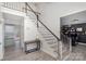 Elegant staircase featuring hardwood steps, white risers, and wrought iron accents at 6087 Diamond Pl, Harrisburg, NC 28075