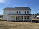 New construction home with a spacious backyard and covered patio, showcasing great architectural details at 619 Amberjack Pl, York, SC 29745