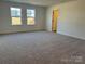 Spacious bedroom featuring neutral carpet and a pair of windows with natural light at 619 Amberjack Pl, York, SC 29745