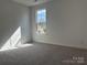 Bright room with neutral walls and carpet, a view from the window, and electrical outlets at 619 Amberjack Pl, York, SC 29745