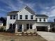 Beautiful two-story home with white siding, brick accents, attached garage, and covered front porch at 619 Amberjack Pl, York, SC 29745