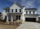 Charming two-story home featuring an attached garage, a light blue front door and a well-manicured lawn at 619 Amberjack Pl, York, SC 29745