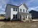 Inviting two-story house with siding, an attached garage, front porch, and nice landscaping at 619 Amberjack Pl, York, SC 29745