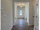 Bright hallway featuring wood flooring and views of a front door letting in plenty of natural light at 619 Amberjack Pl, York, SC 29745