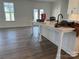 A kitchen with a white island, wooden floors, and stainless steel appliances at 619 Amberjack Pl, York, SC 29745