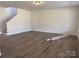 Expansive living room featuring wood-look flooring, a staircase, and ample space for entertaining at 619 Amberjack Pl, York, SC 29745