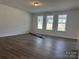 Open-concept living room with wood floors, recessed lighting and natural light coming from the windows at 619 Amberjack Pl, York, SC 29745