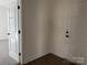 An interior room with a closet, and an exterior door, and neutral-toned walls at 619 Amberjack Pl, York, SC 29745