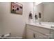 Modern powder room features bright white cabinets, marble countertop, contemporary fixtures, and decorative art at 6275 Tea Olive Dr # 176, Harrisburg, NC 28075