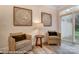 Bright sitting room area featuring cozy chairs, natural light, and elegant decor near a glass sliding door at 6275 Tea Olive Dr # 176, Harrisburg, NC 28075