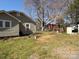 View of home's backyard with shed and detached garage surrounded by lush green grass at 701 Betty St, Gastonia, NC 28054