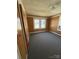 Bedroom with gray carpet, wood paneled walls, and a window at 701 Betty St, Gastonia, NC 28054