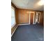 Bedroom featuring classic wood paneling, natural light, and a doorway leading to other rooms at 701 Betty St, Gastonia, NC 28054