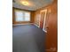 Bright bedroom with wood-paneled walls, carpet, and natural light streaming through the window at 701 Betty St, Gastonia, NC 28054