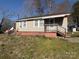 Bungalow-style house with a covered porch, siding, and brick foundation at 701 Betty St, Gastonia, NC 28054