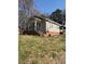 Bungalow-style house with a covered porch, siding, and brick foundation at 701 Betty St, Gastonia, NC 28054