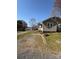 Angle view of home with gravel driveway leading to the side porch entrance at 701 Betty St, Gastonia, NC 28054