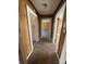 Hallway with carpet and wood paneled walls connecting multiple rooms at 701 Betty St, Gastonia, NC 28054