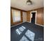 Charming living room featuring wood paneling, natural light, and inviting entrance to other rooms at 701 Betty St, Gastonia, NC 28054