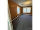 Well-lit living room with natural wood paneling and natural light from windows at 701 Betty St, Gastonia, NC 28054